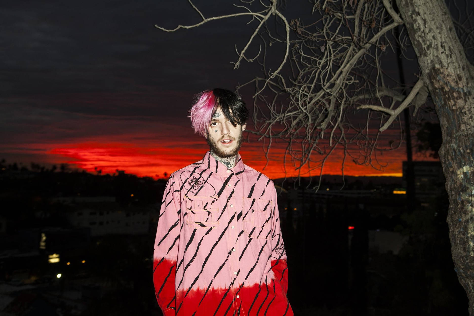 Lil Peep looks out into the horizon in a beautiful sunset Wallpaper