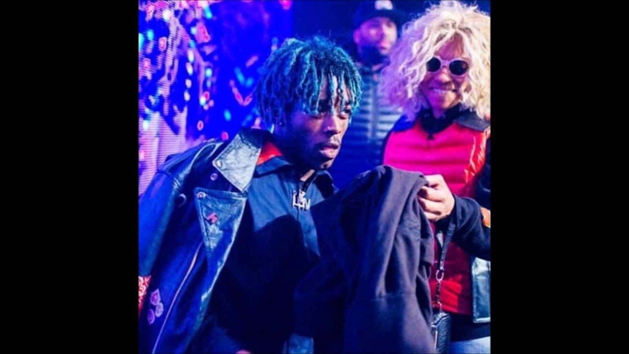 Lil Uzi Vert striking a pose on stage during a live performance