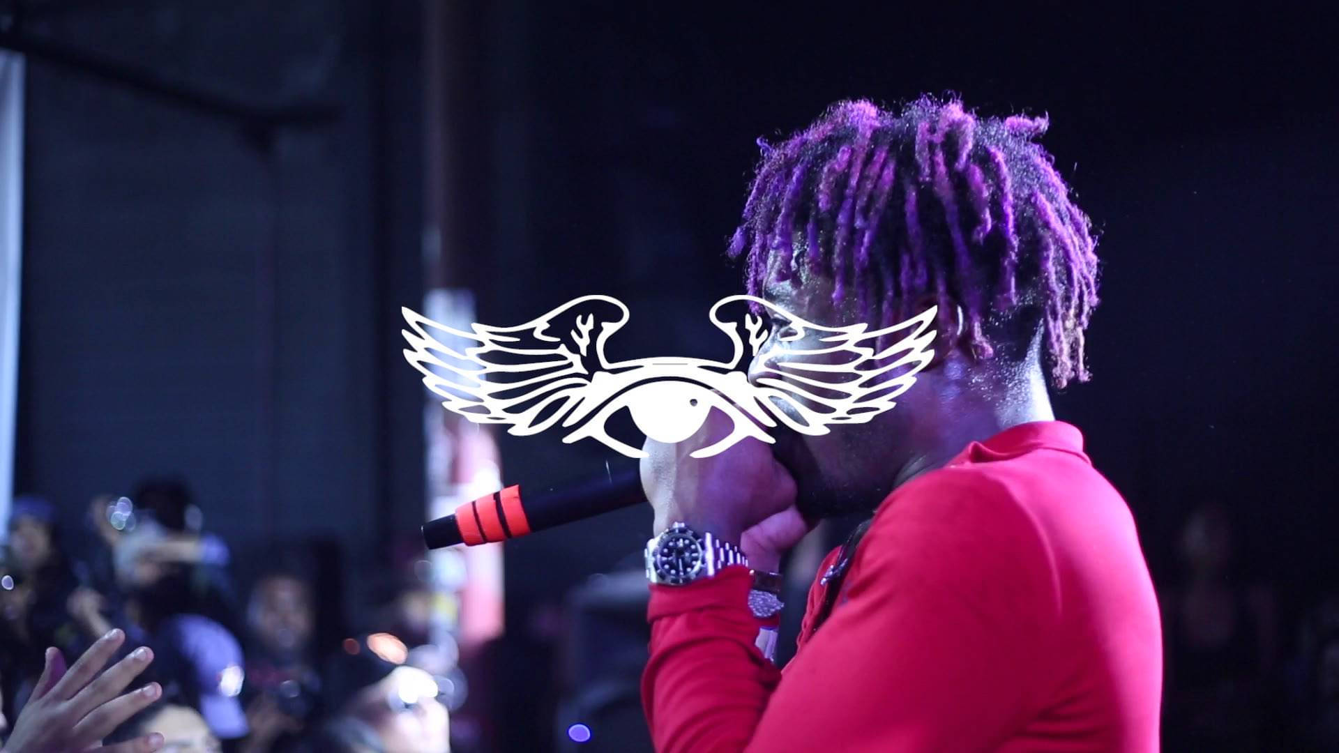 Lil Uzi Vert putting on an electrifying show in front of a hyped-up crowd Wallpaper