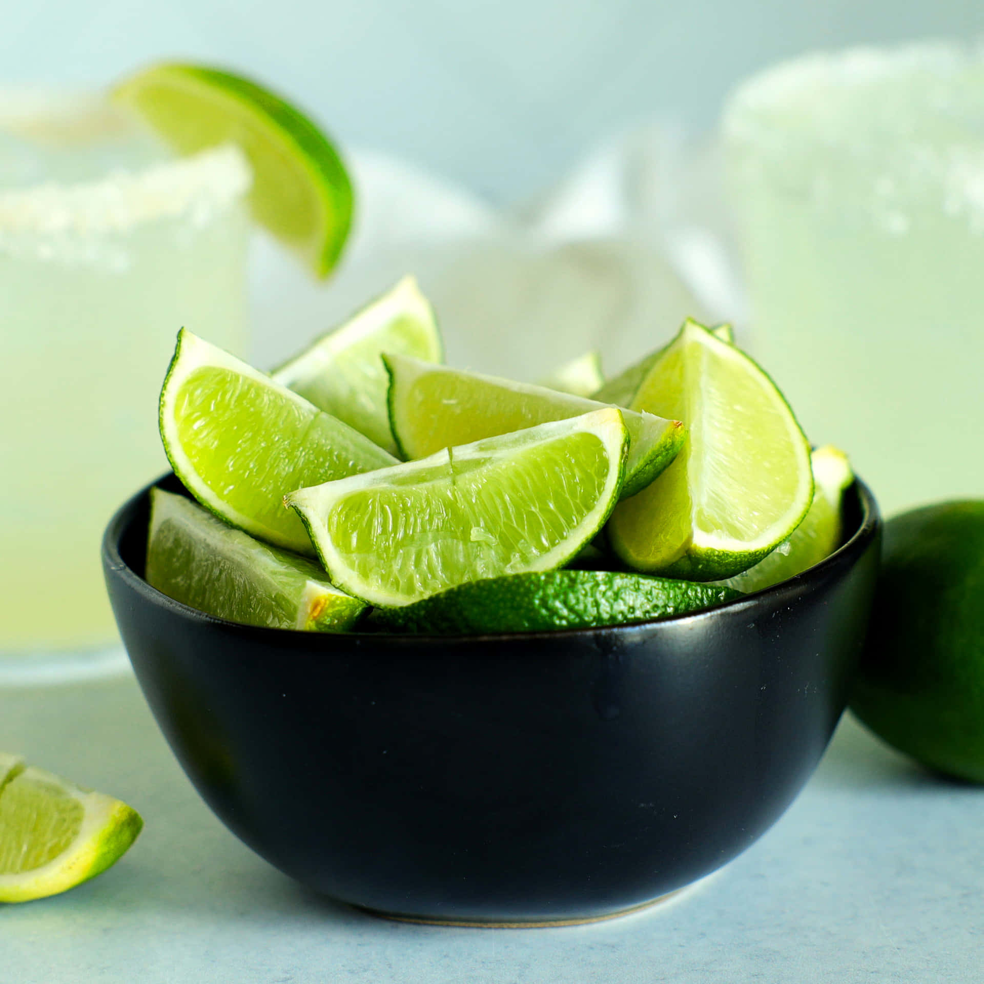 A Bowl Of Limes And A Glass Of Margarita