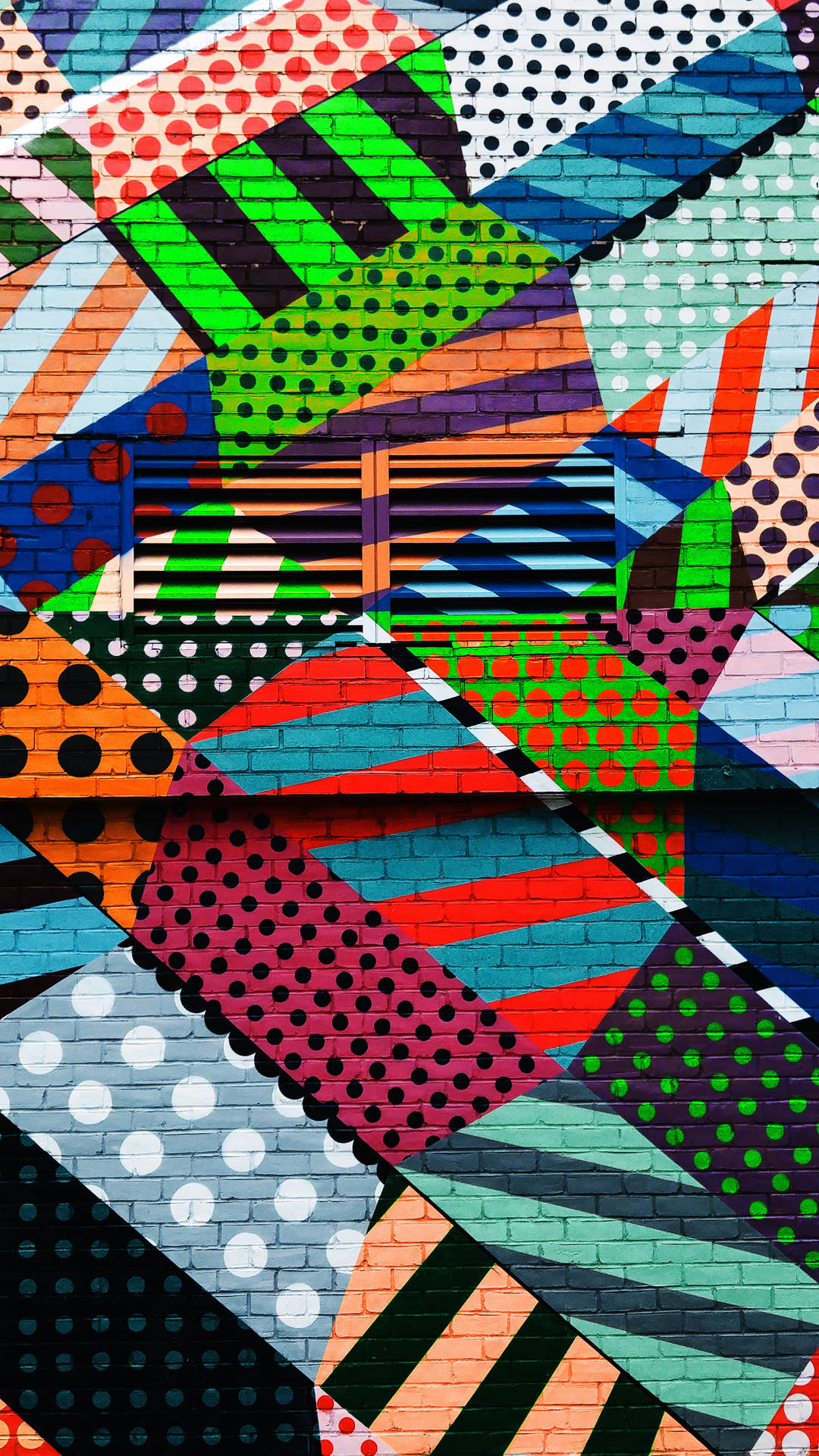 Abstract graffiti wallpaper of multi-colored lines and polka dots.