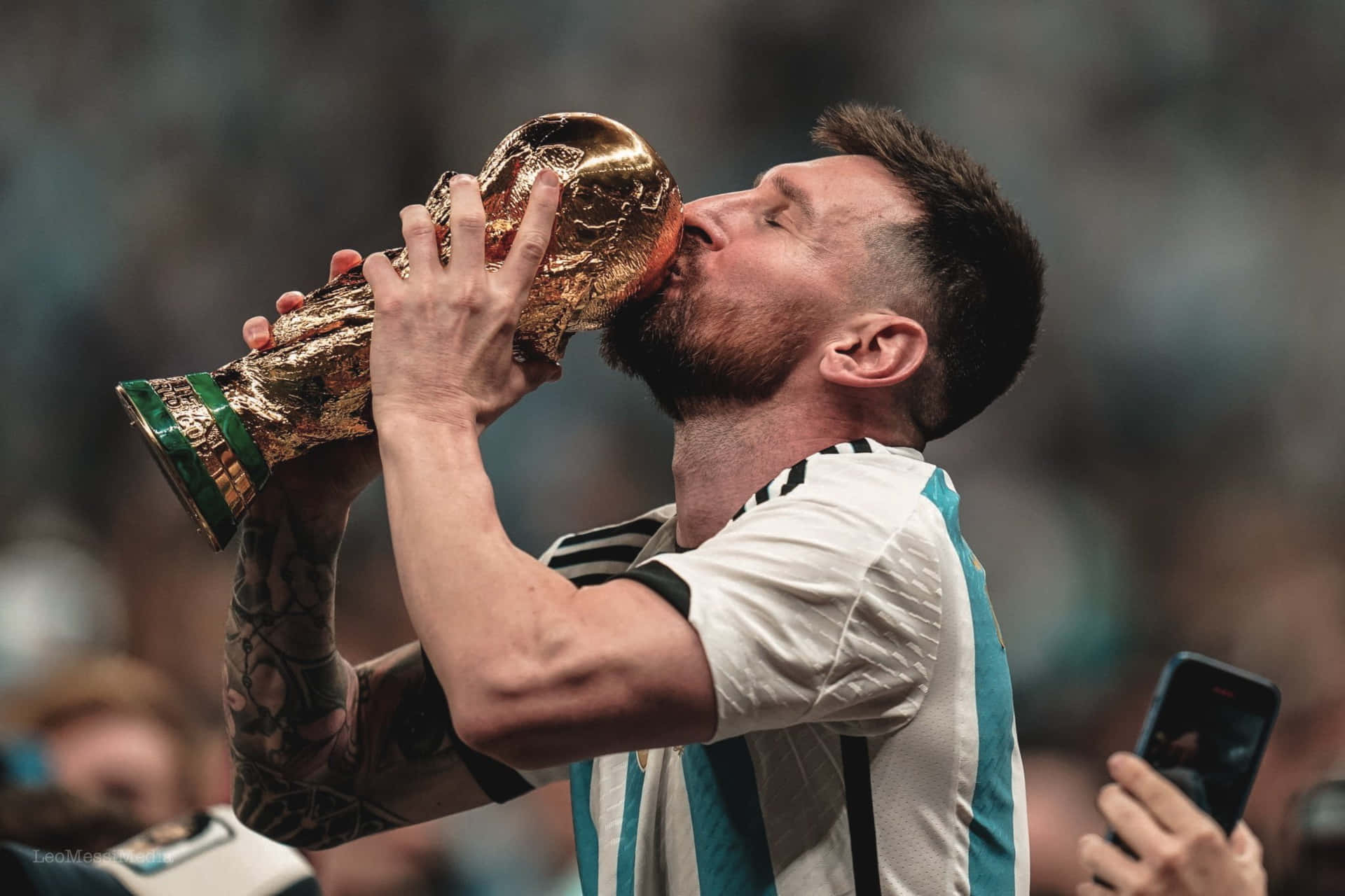 A Man Kissing The Trophy With His Hands Wallpaper