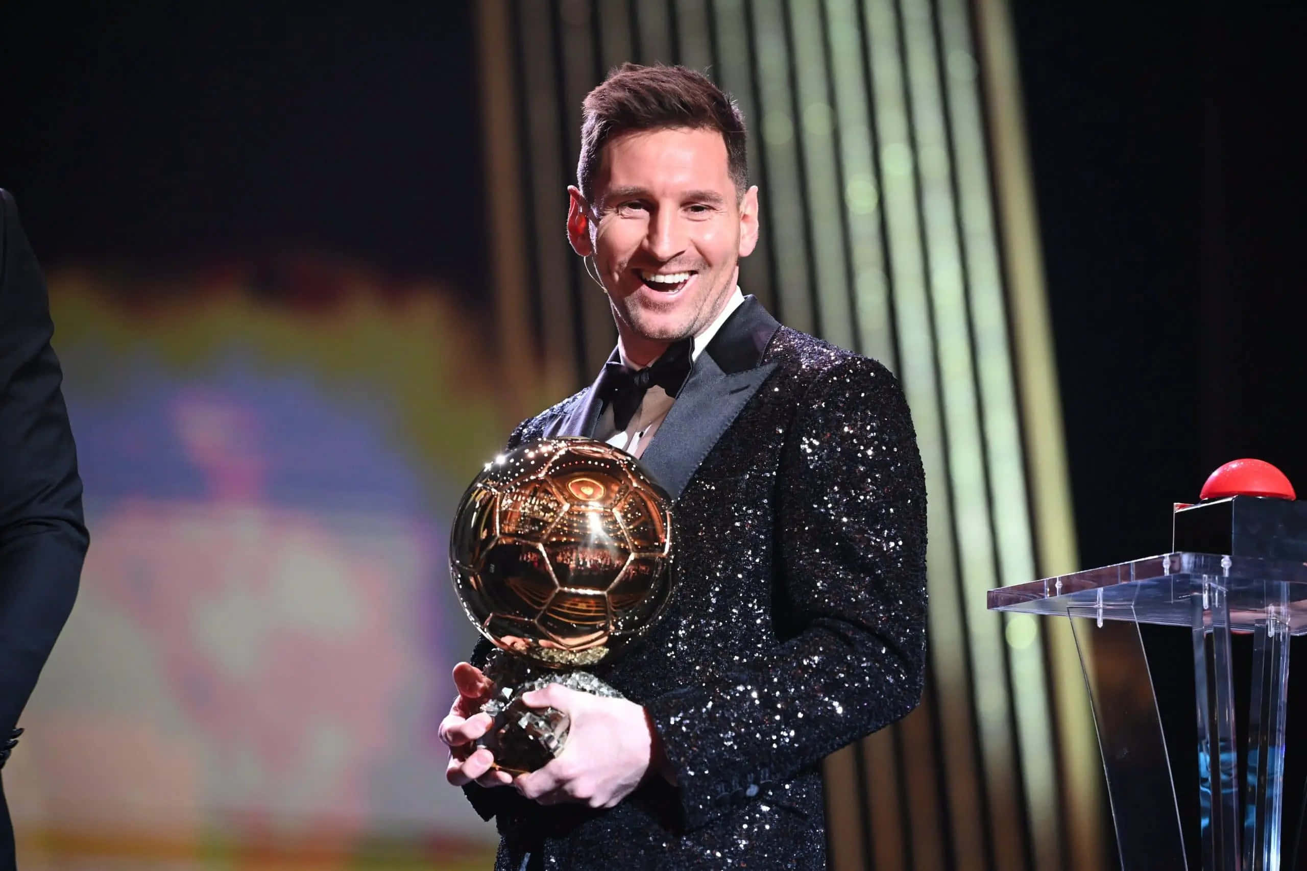Lionel Messi Proudly Holding The Prestigious Ballon D'or. Wallpaper