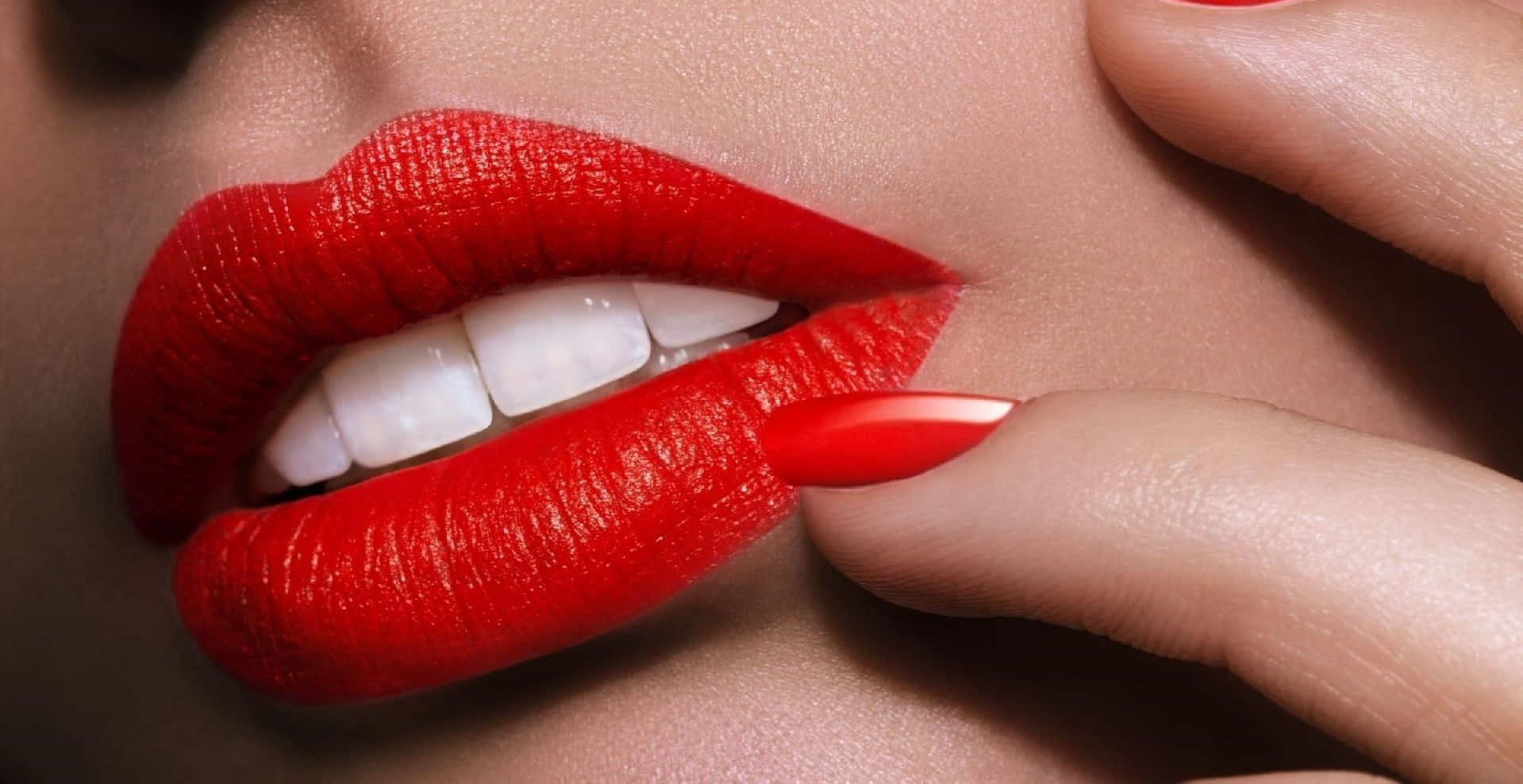 Close-up of luscious red lips on a dark background
