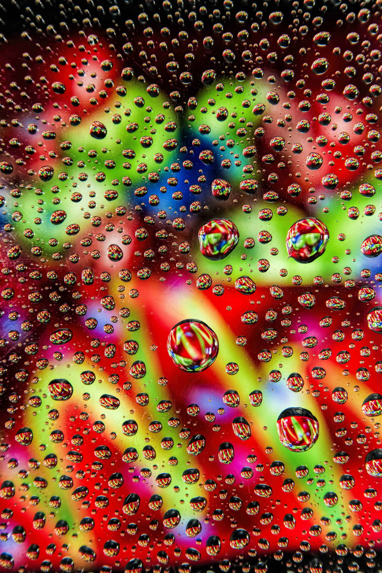 Water Droplets On A Glass With Colorful Lights