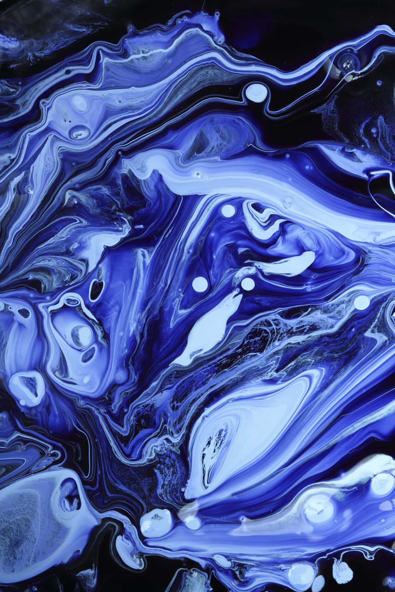 A Blue Liquid With Swirls Of Black And White