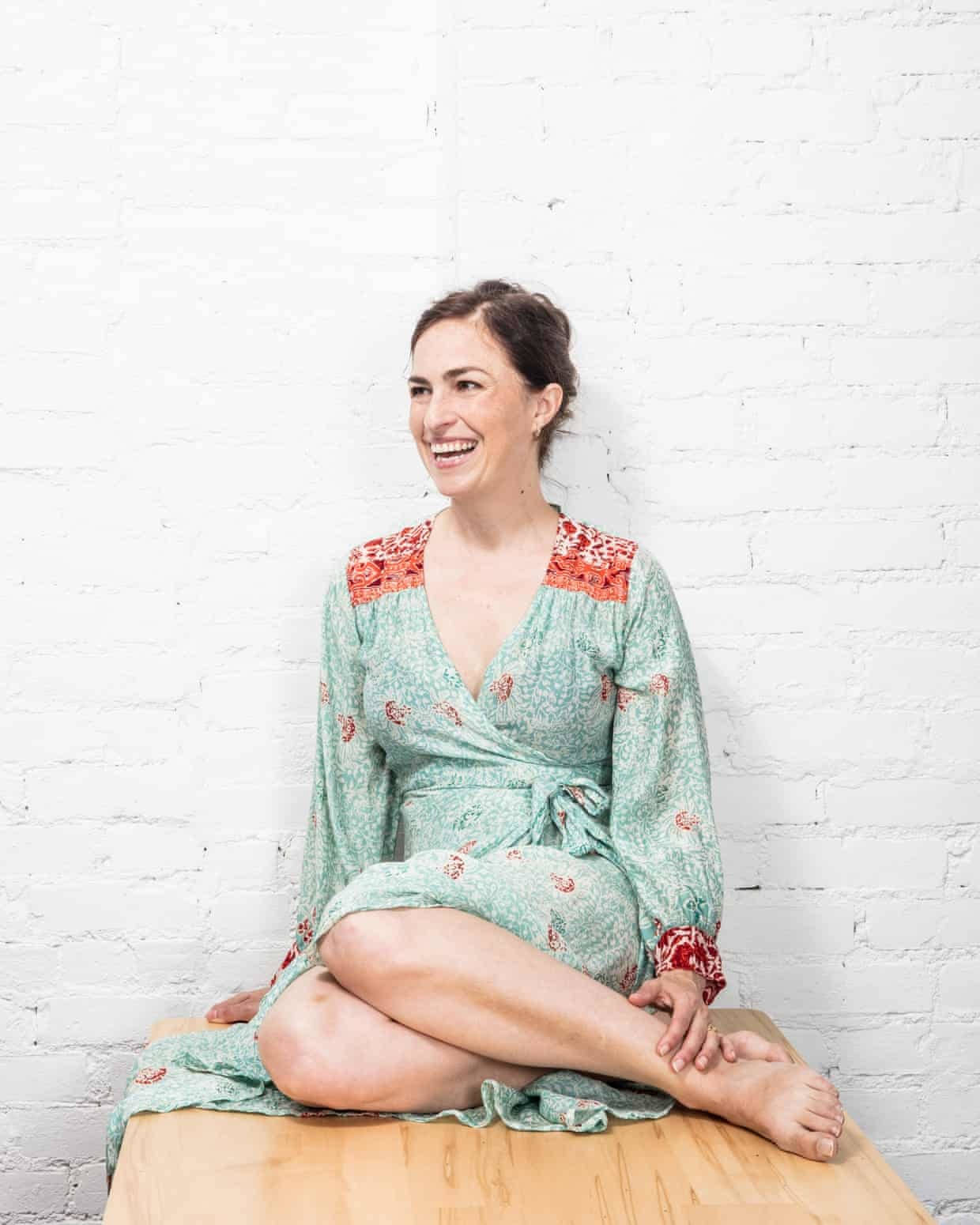 Lisa Brennan Jobs In A Green Floral Wrap Around Dress Background