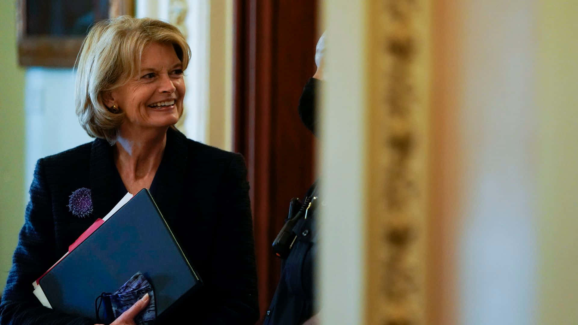 U.S. Senator Lisa Murkowski Smiling and Holding Documents. Wallpaper