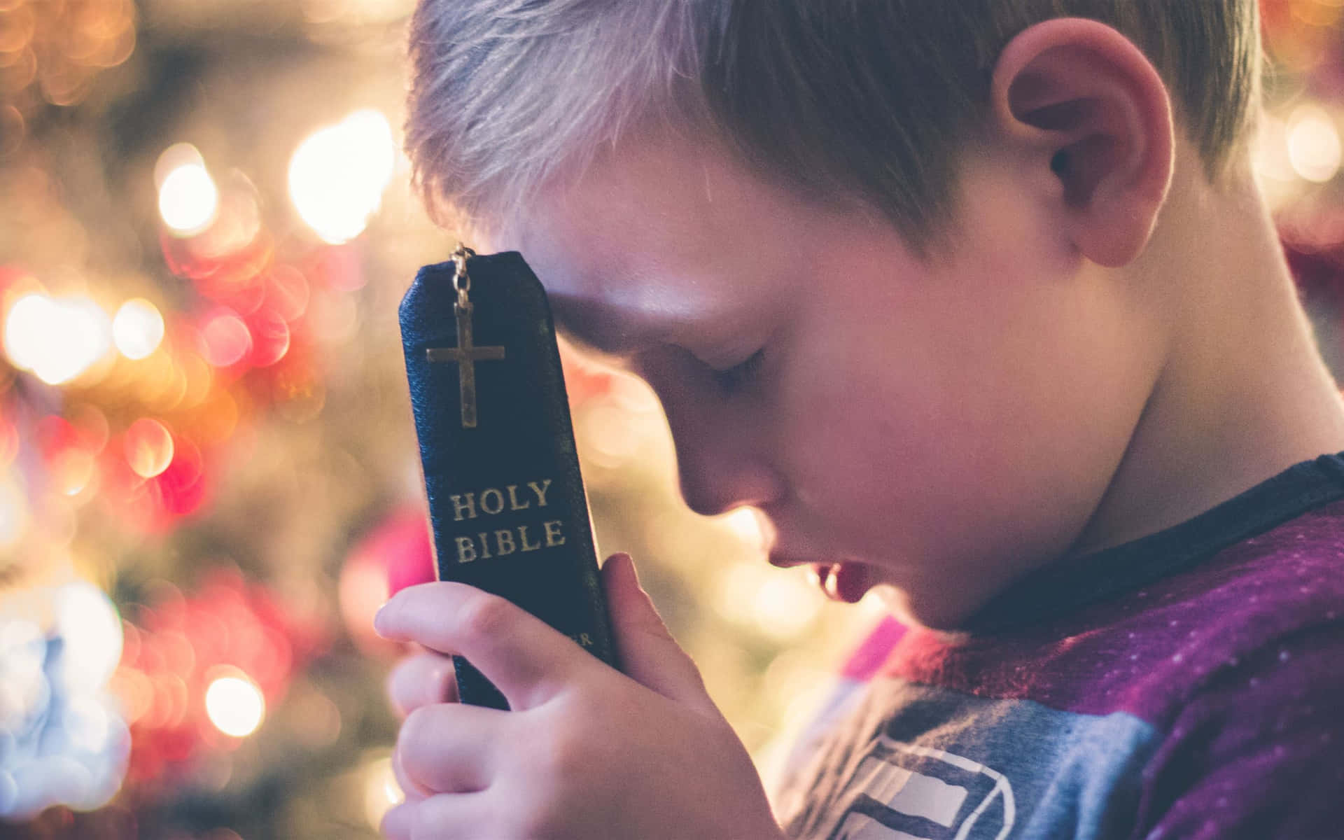 Little Child With Holy Bible Wallpaper