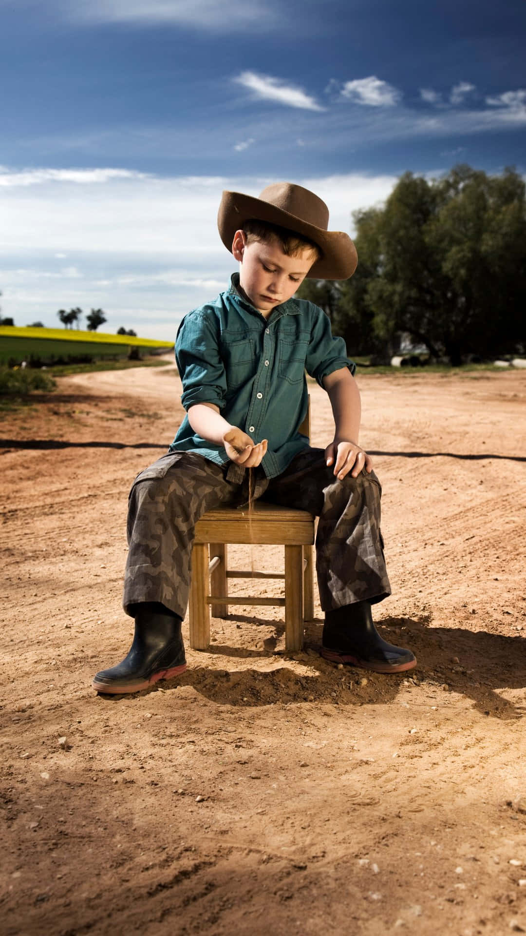 Little Cowboy Playingin Dirt.jpg Wallpaper