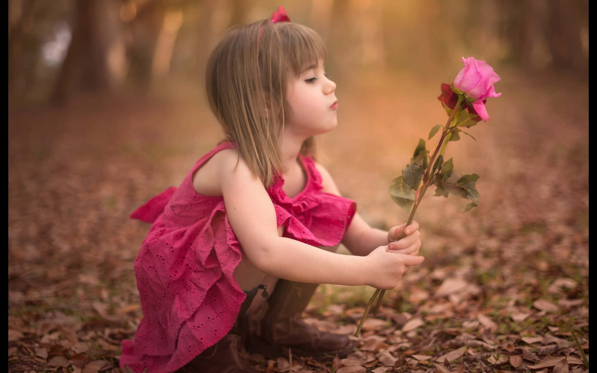 Little Girl Admiring Rose Outdoors Wallpaper