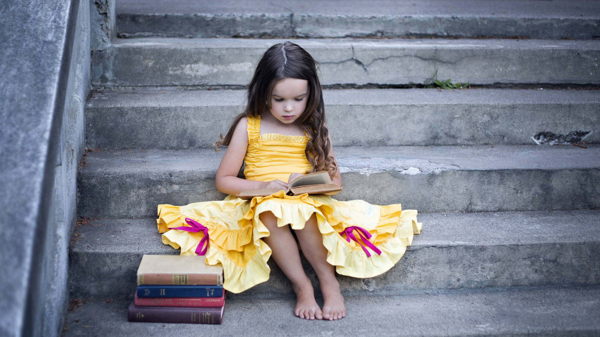 Little Girl Reading Book At Stairs Wallpaper