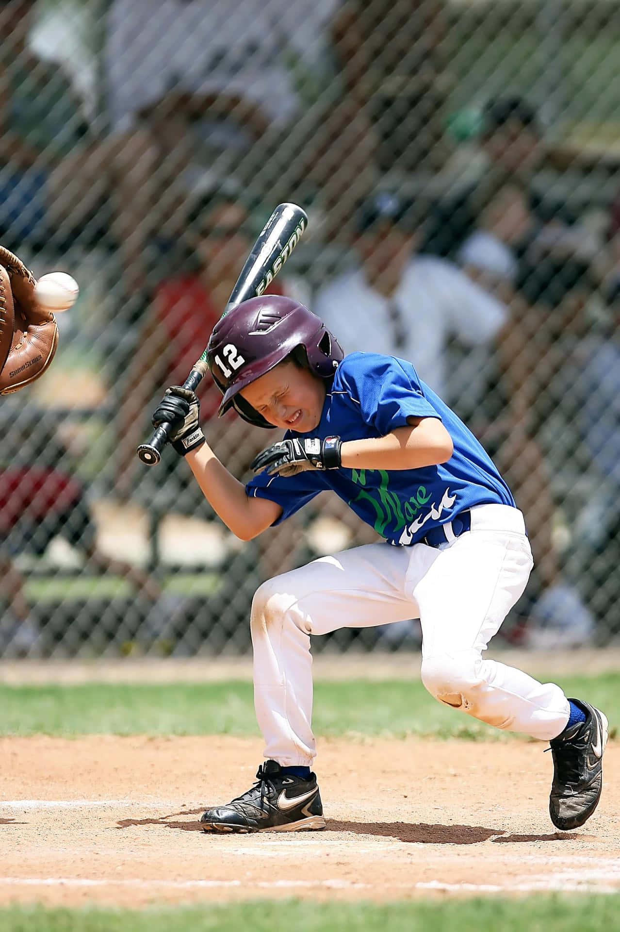 Little League Baseball team in action on the field Wallpaper