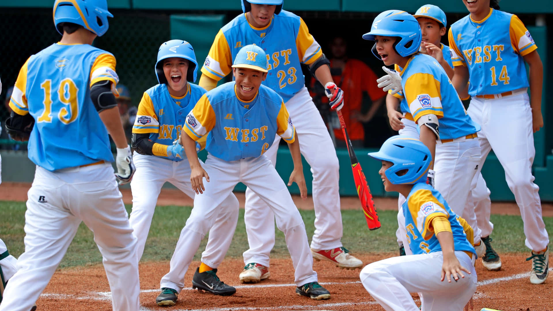 Download Little League Baseball Action Shot Two Players Celebrating Victory Wallpaper