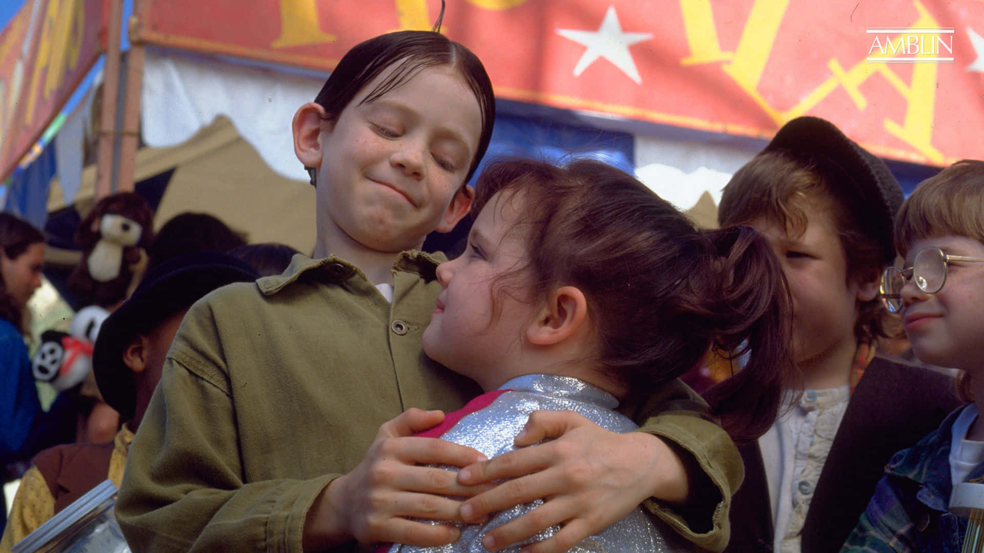 A Group Of Children Hugging In Front Of A Tent