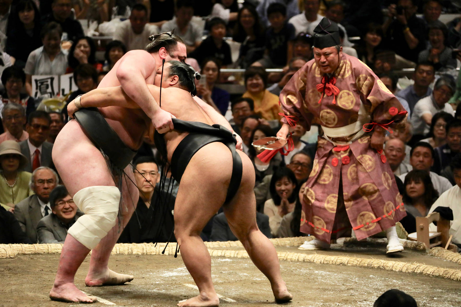 Two Sumo Wrestlers Clashing in an Epic Showdown Wallpaper