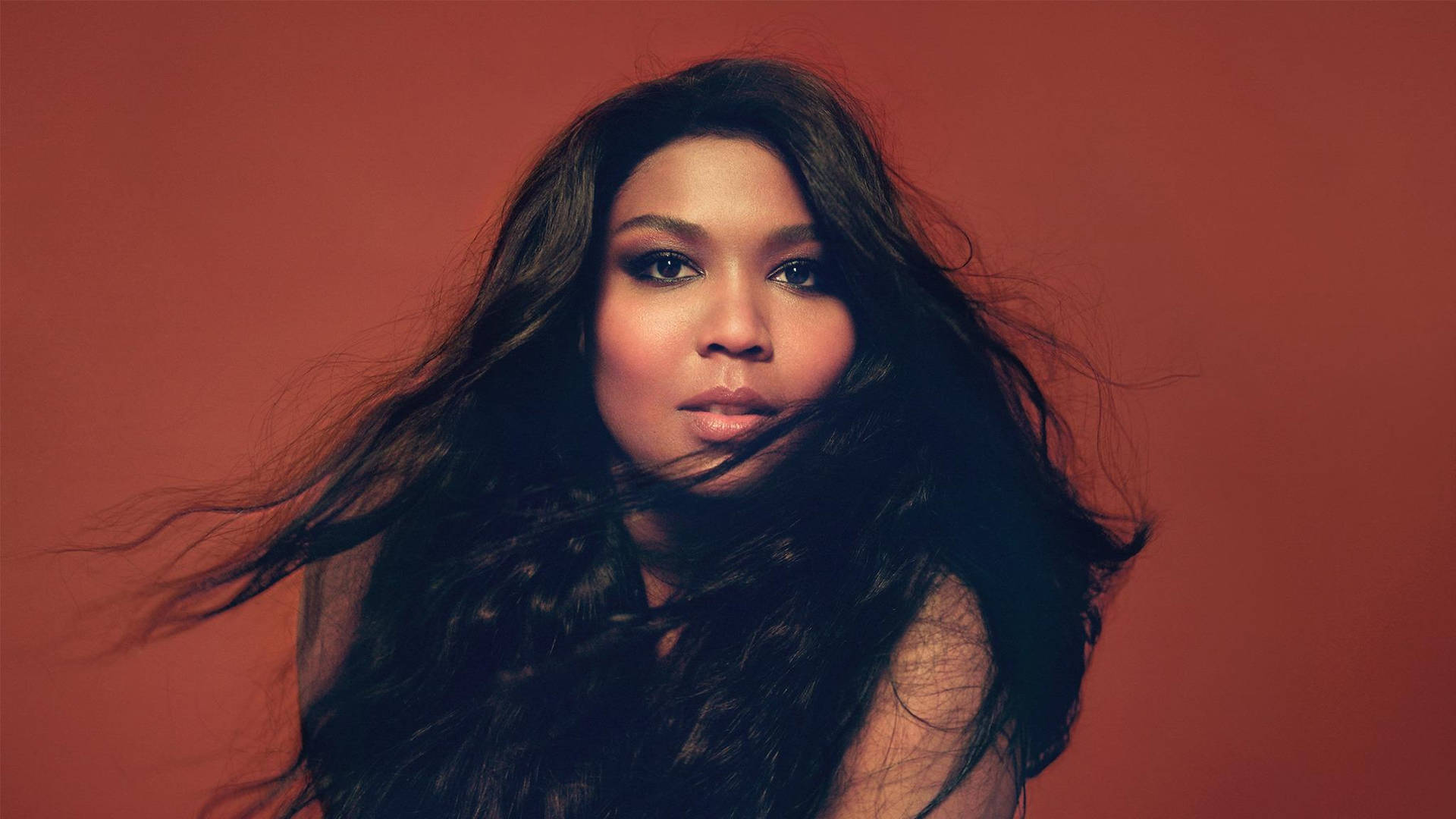 Lizzo In Red Brown Background