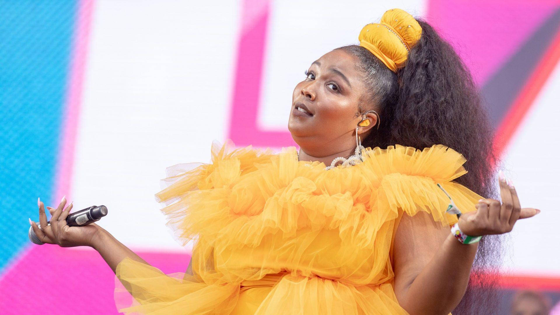 Lizzo In Yellow Frilly Outfit Background