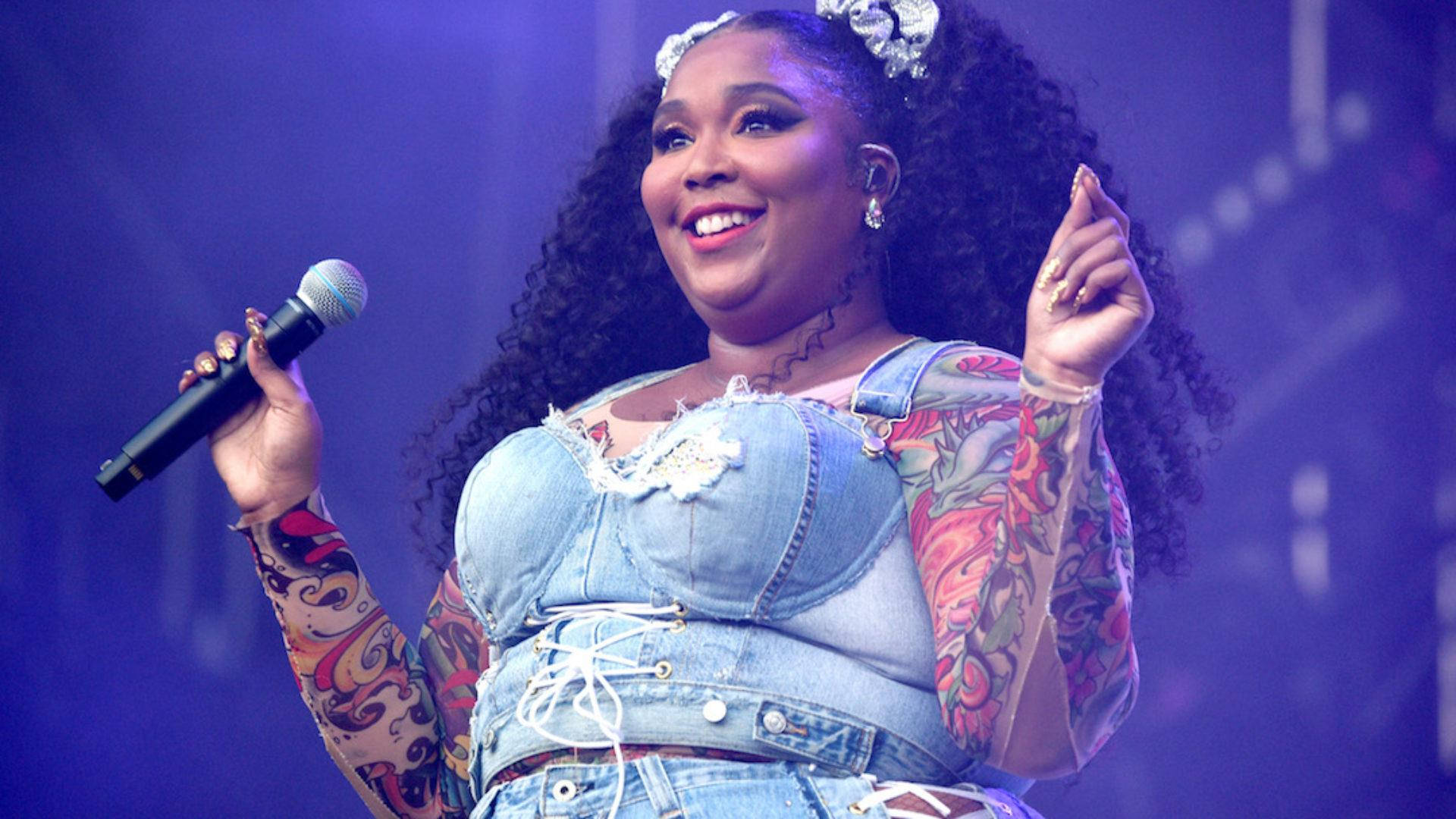Lizzo With Tattooed Body Suit Background