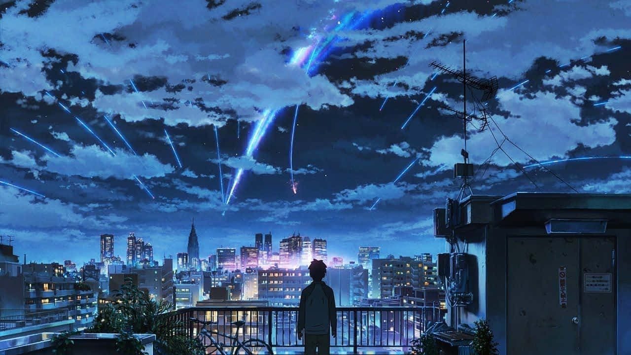 En mand står på et tag og kigger ned på byens skyline. Wallpaper