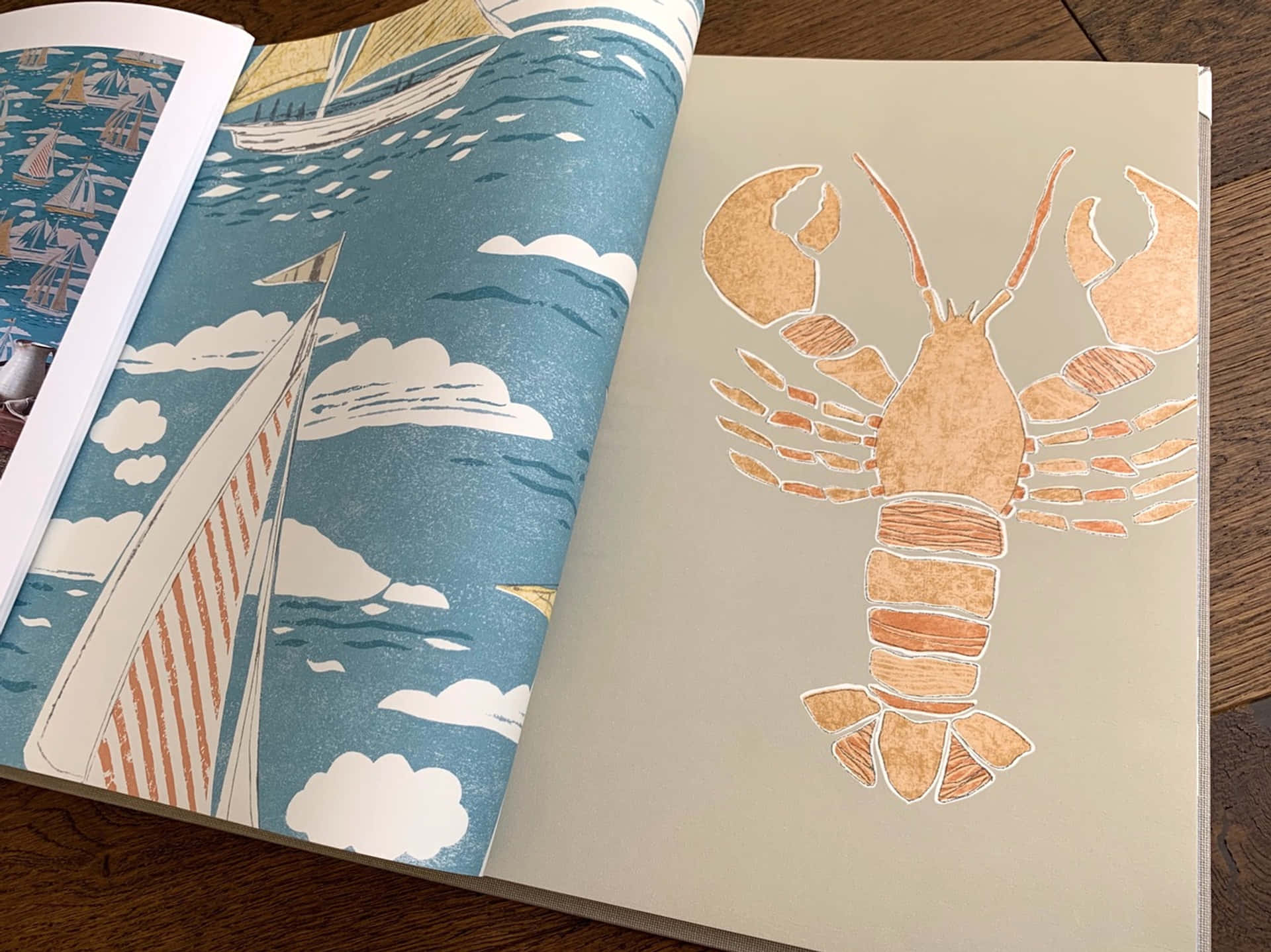 A Book With A Lobster On It And A Sailboat