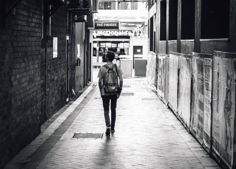 Lonely Boy Walking Down An Alley Wallpaper