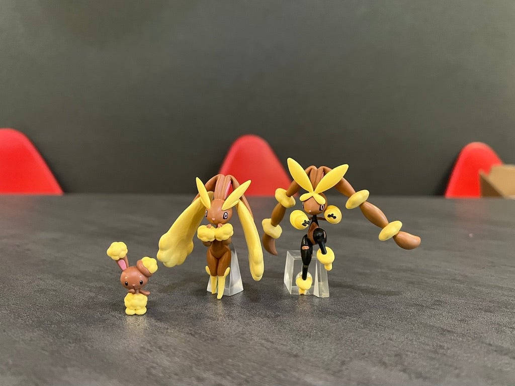 a group of figurines with a yellow and brown color Wallpaper