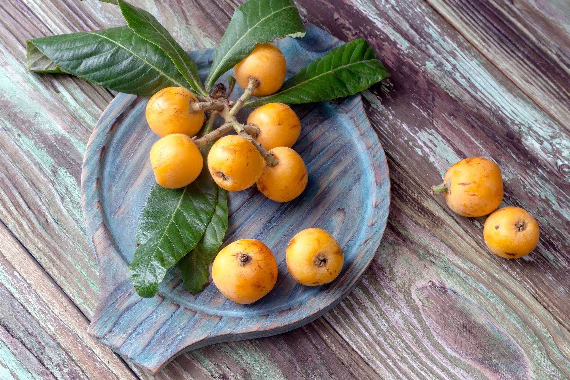 Fresh Loquat Fruits Placed on a Marble Plate Wallpaper