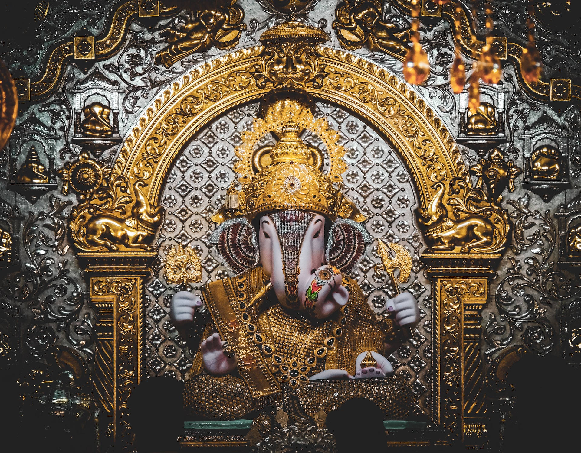 Majestic Lord Ganesh Altar In Silver And Gold Wallpaper