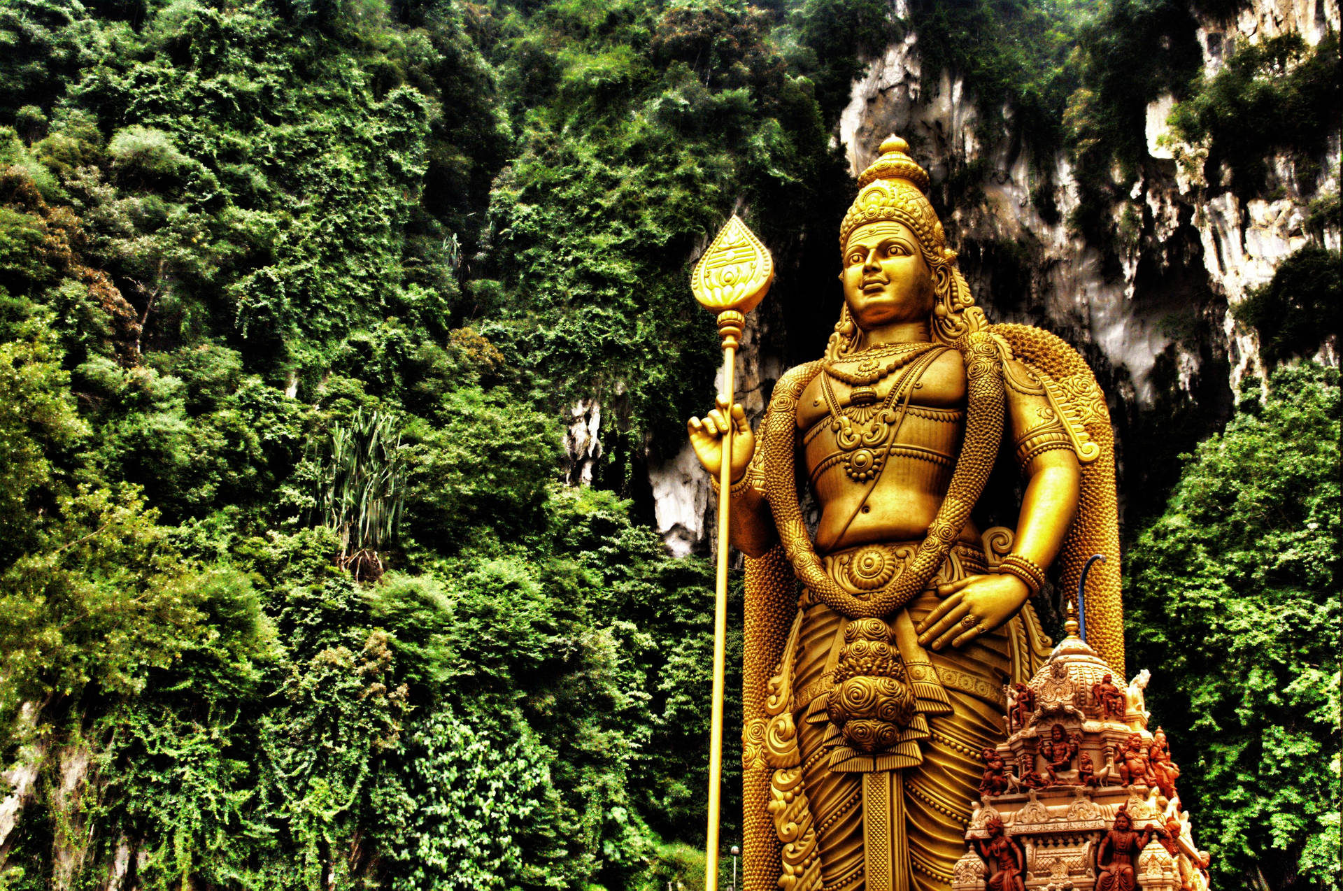 Lord Murugan Statue Surrounded by Trees Wallpaper