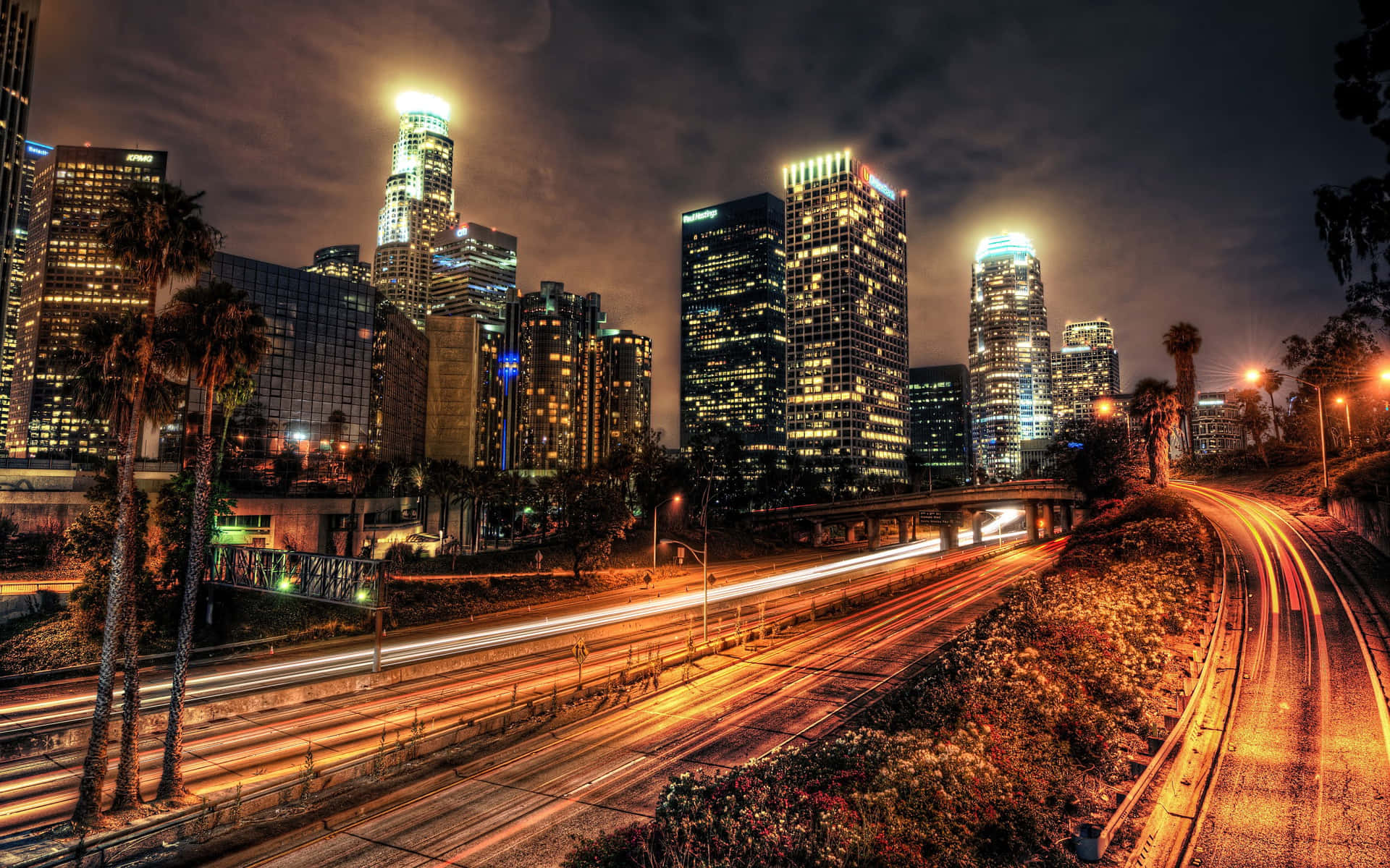 A mesmerizing view of the Los Angeles skyline at night with illuminated buildings and streets