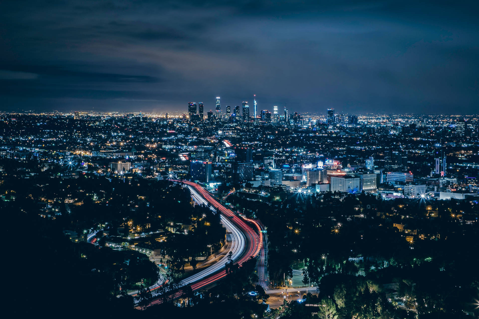 An aerial view of the nighttime Los Angeles skyline Wallpaper