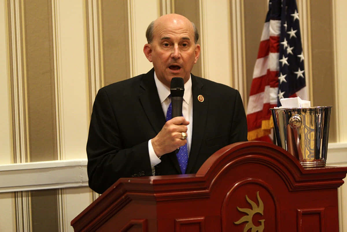 Congressman Louie Gohmert passionately speaking into a microphone Wallpaper
