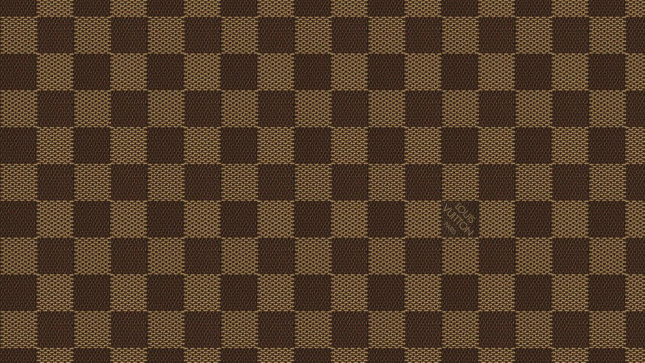 Experience the timeless style of Louis Vuitton with this classic checkered design Wallpaper