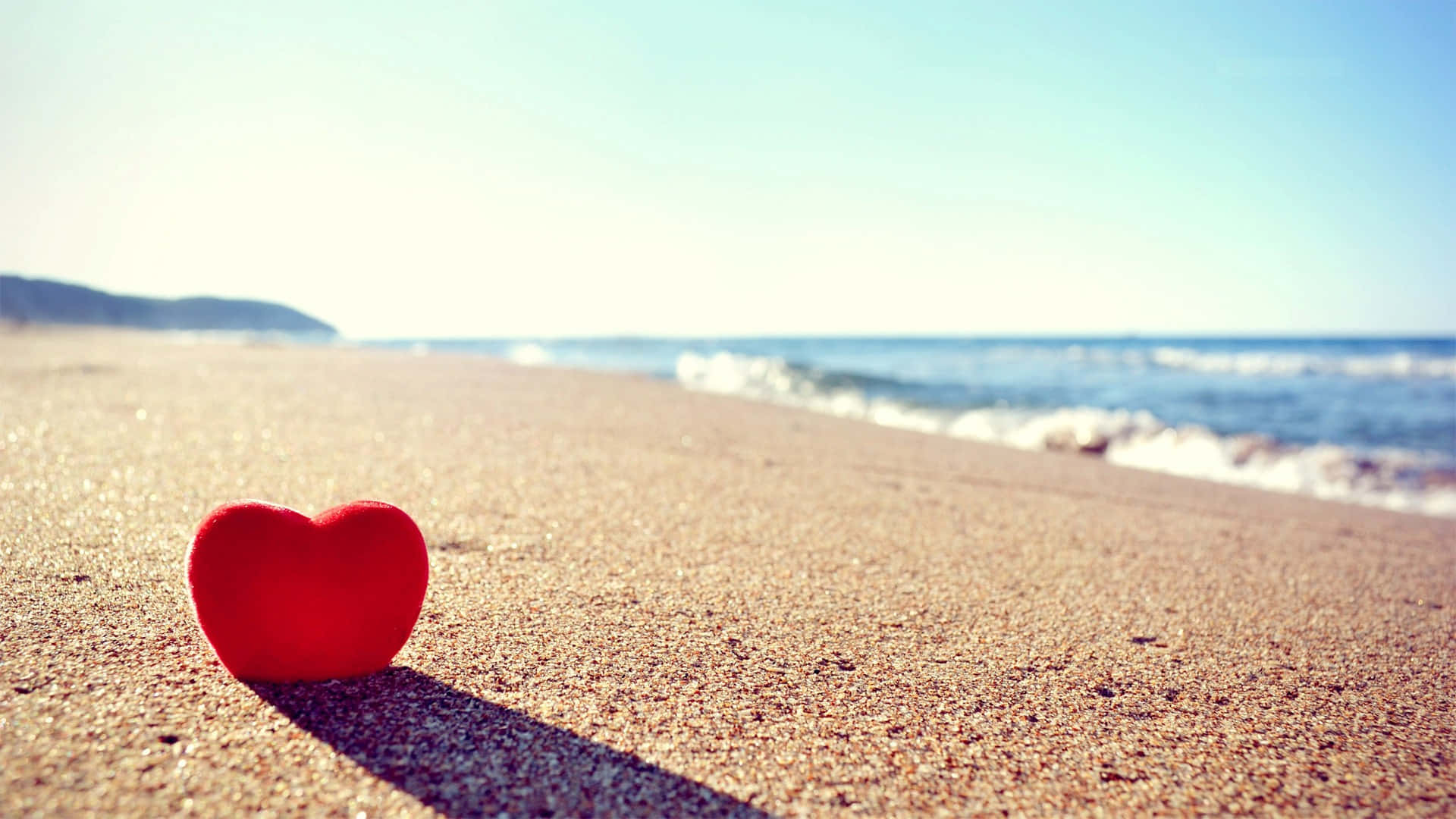 Astounding Red Heart In Sand Love Background