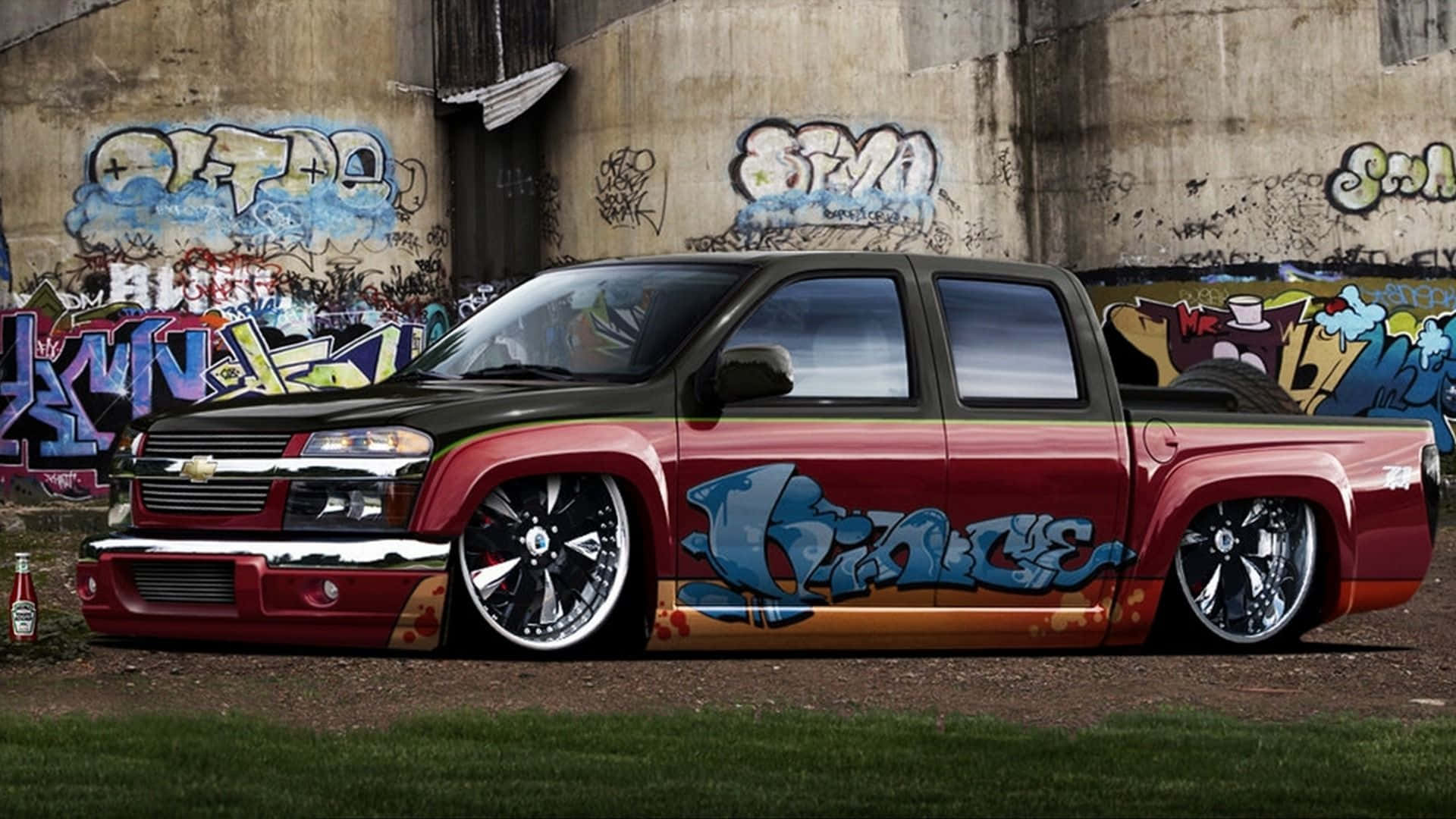 A Red And Black Truck With Graffiti On It Wallpaper