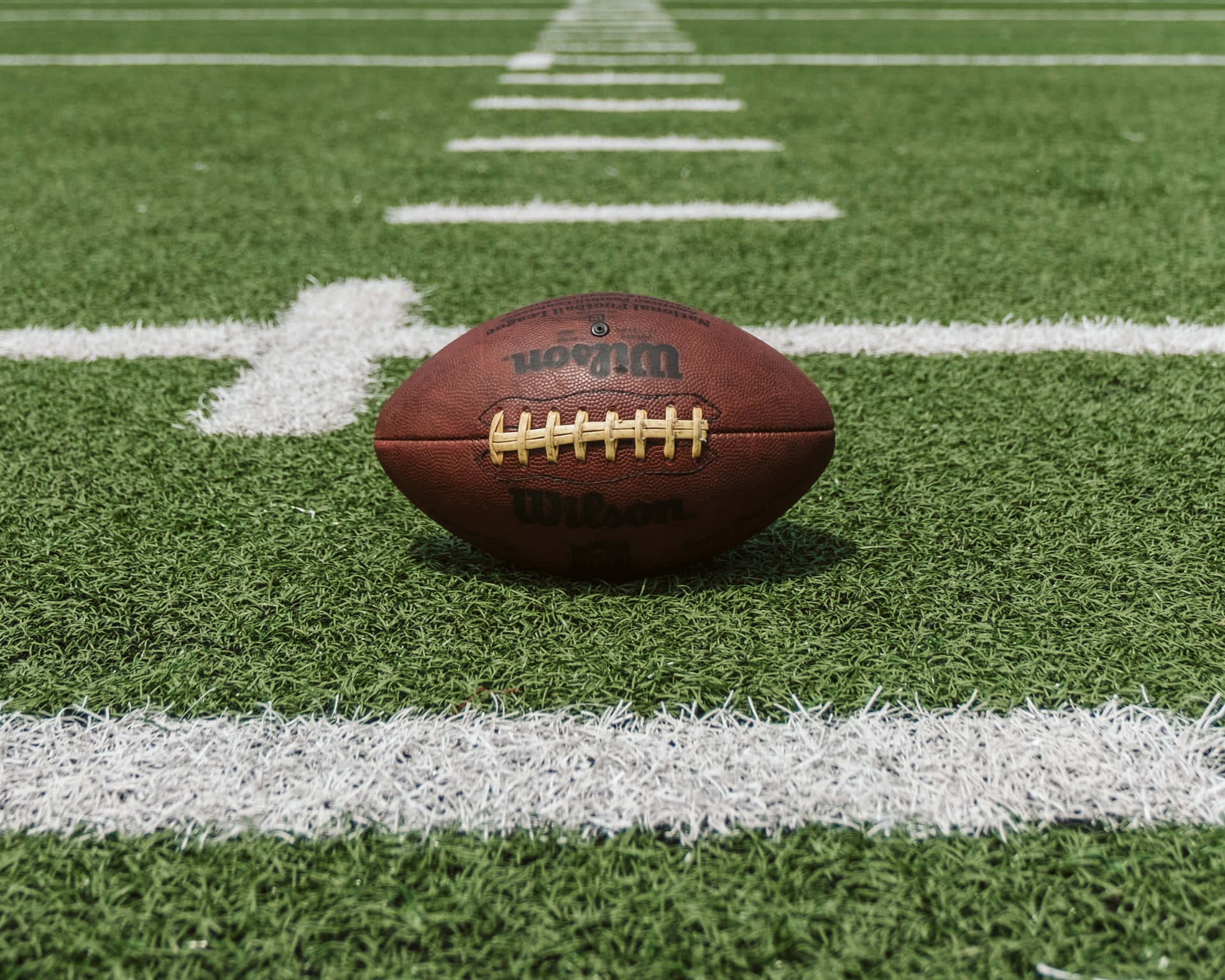 A Football Is Sitting On The Field Wallpaper