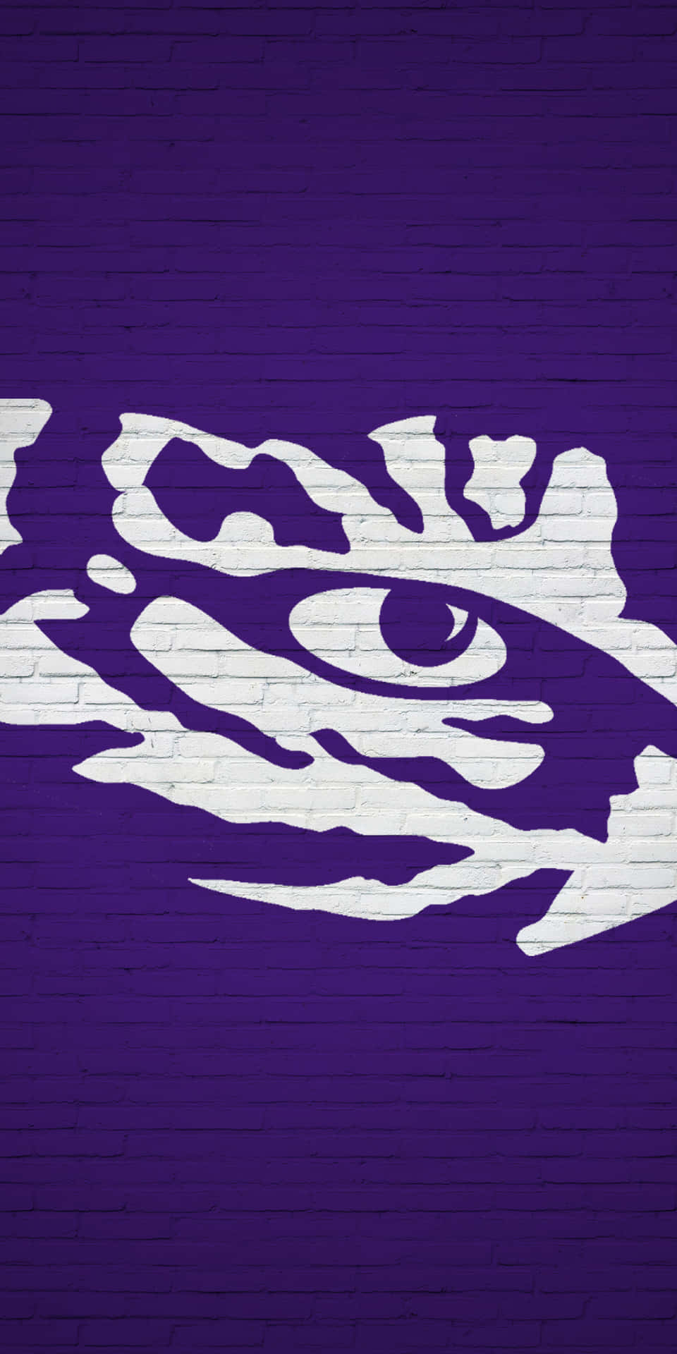 A Purple And White Tiger Logo On A Brick Wall Wallpaper