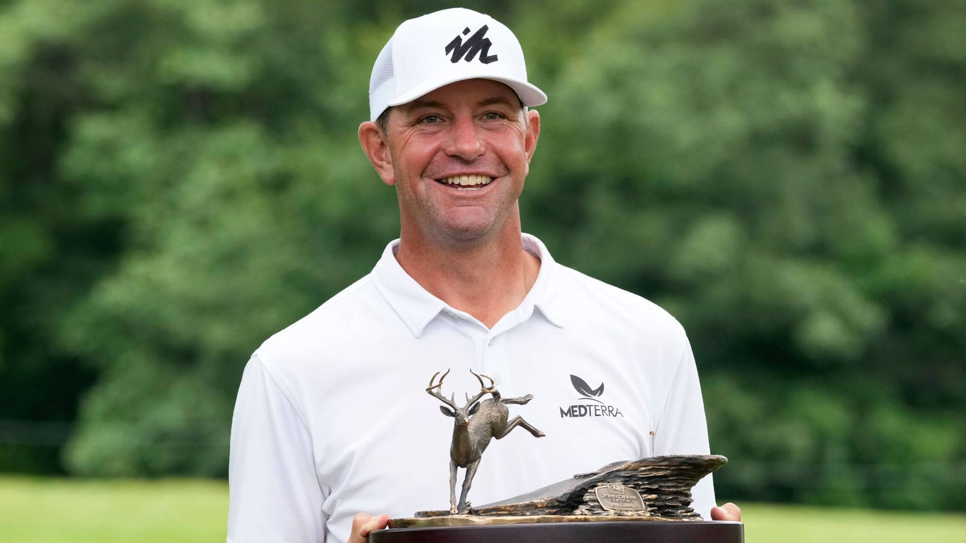 Lucas Glover Triumphantly Displaying Championship Trophy Wallpaper