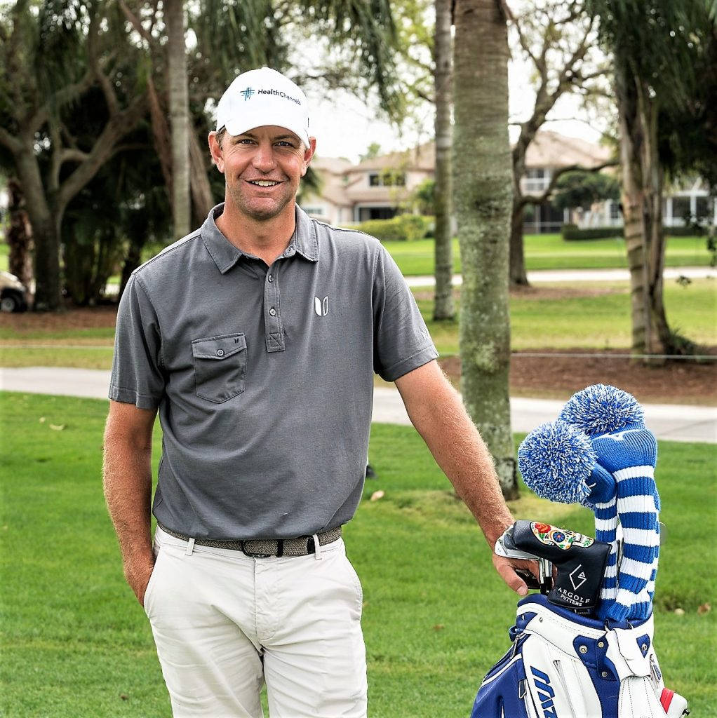 Lucas Glover Poised on the Golf Field with his Golf Bag Wallpaper
