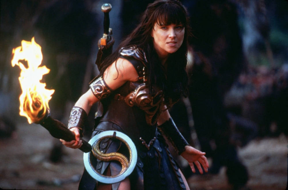 Lucy Lawless With Burning Torch Wallpaper