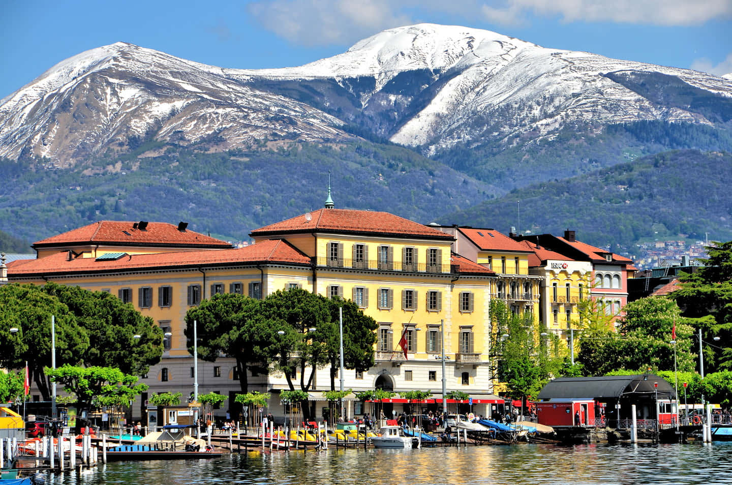 Lugano Lakefrontwith Snow Capped Mountain Backdrop Wallpaper