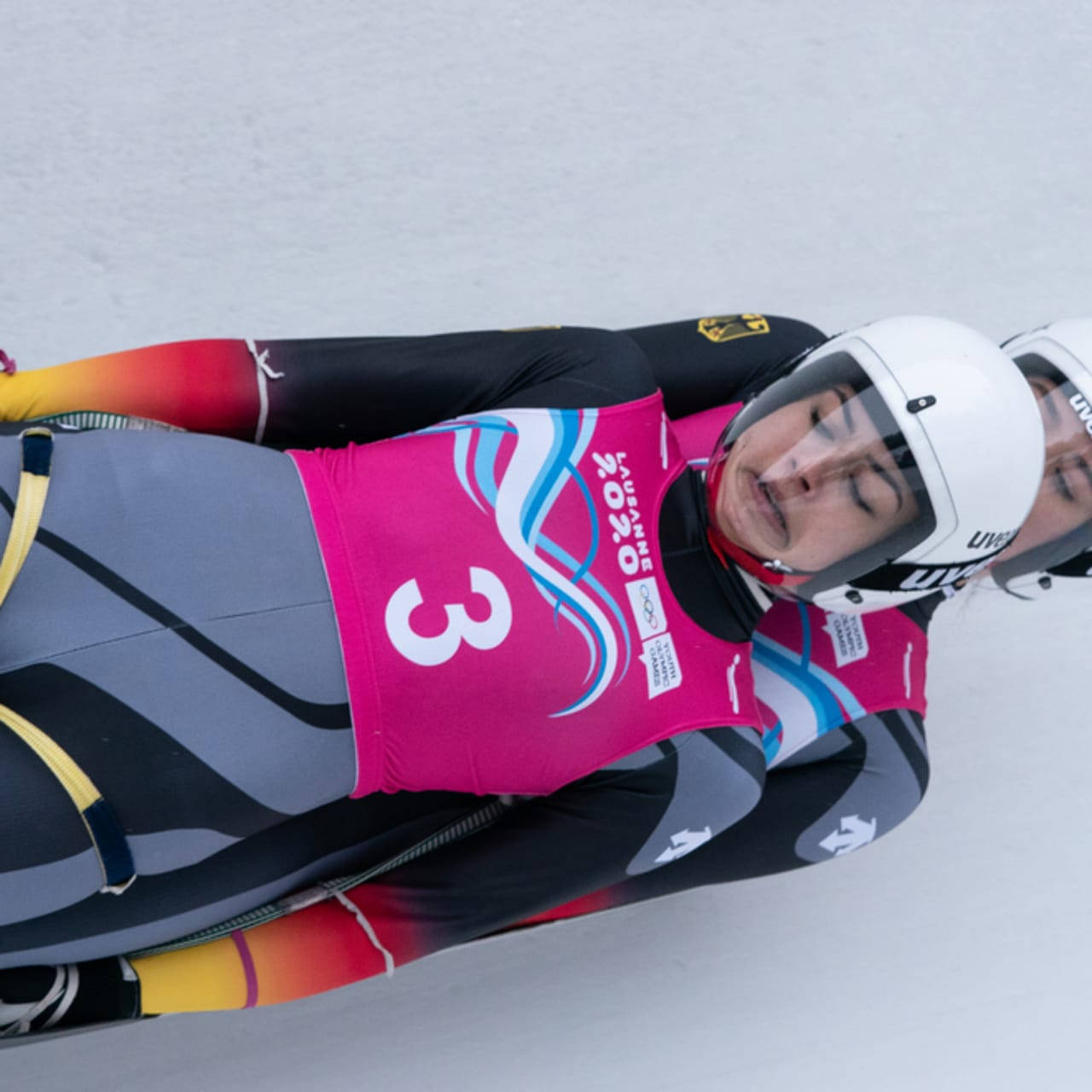 Luge Athletes In Pink Suits Wallpaper