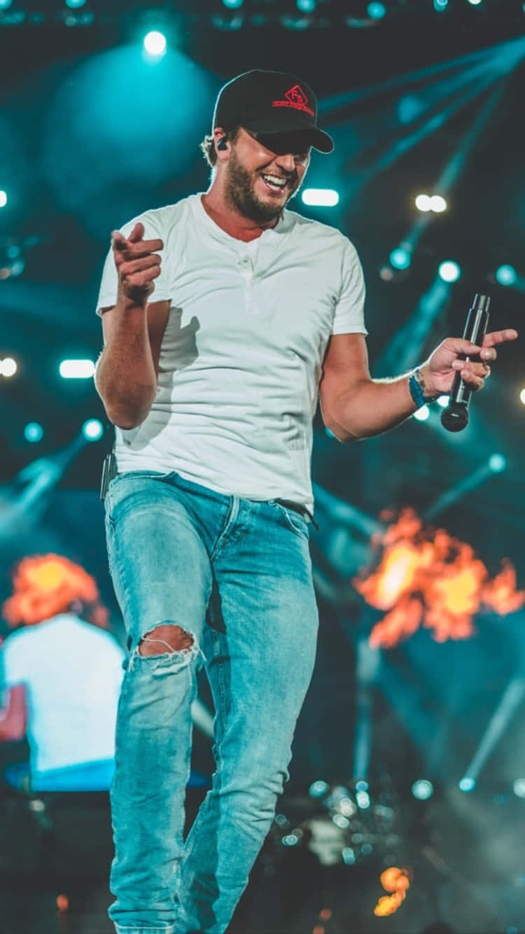 Singer Luke Bryan gracing the stage with his powerful vocals." Wallpaper