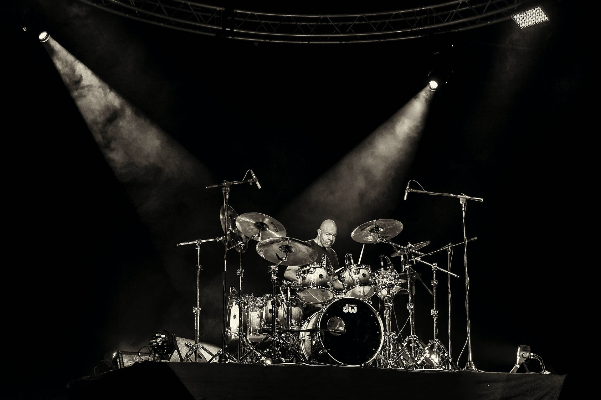 A Drummer On Stage With Spotlights Wallpaper