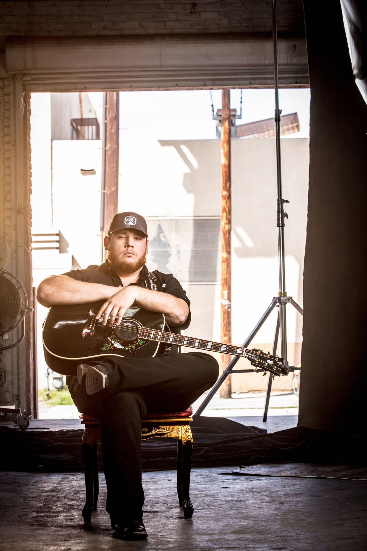 Luke Combs on Stage Performing at an Event Wallpaper