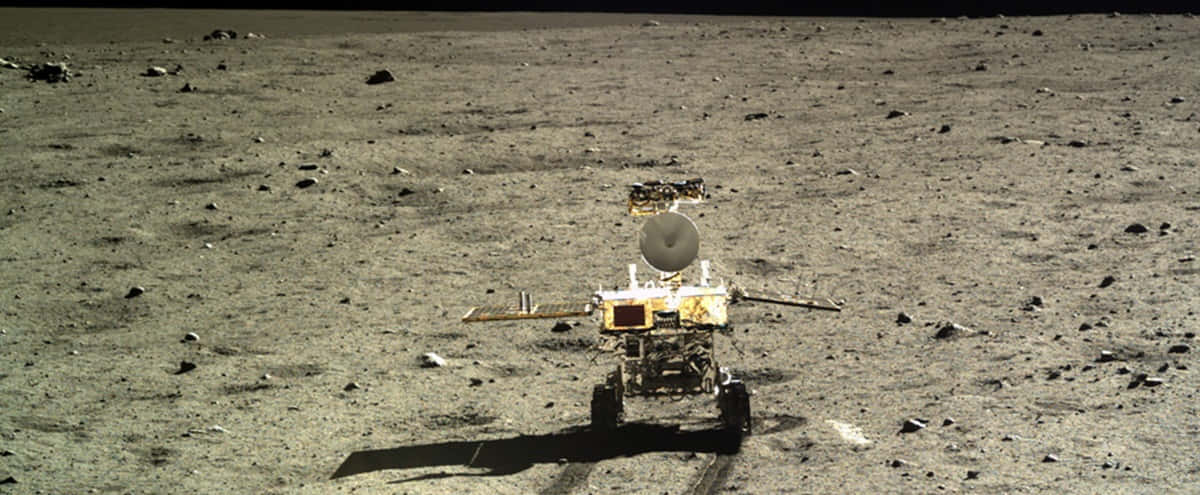 Lunar Rover Exploring The Moon's Surface Wallpaper