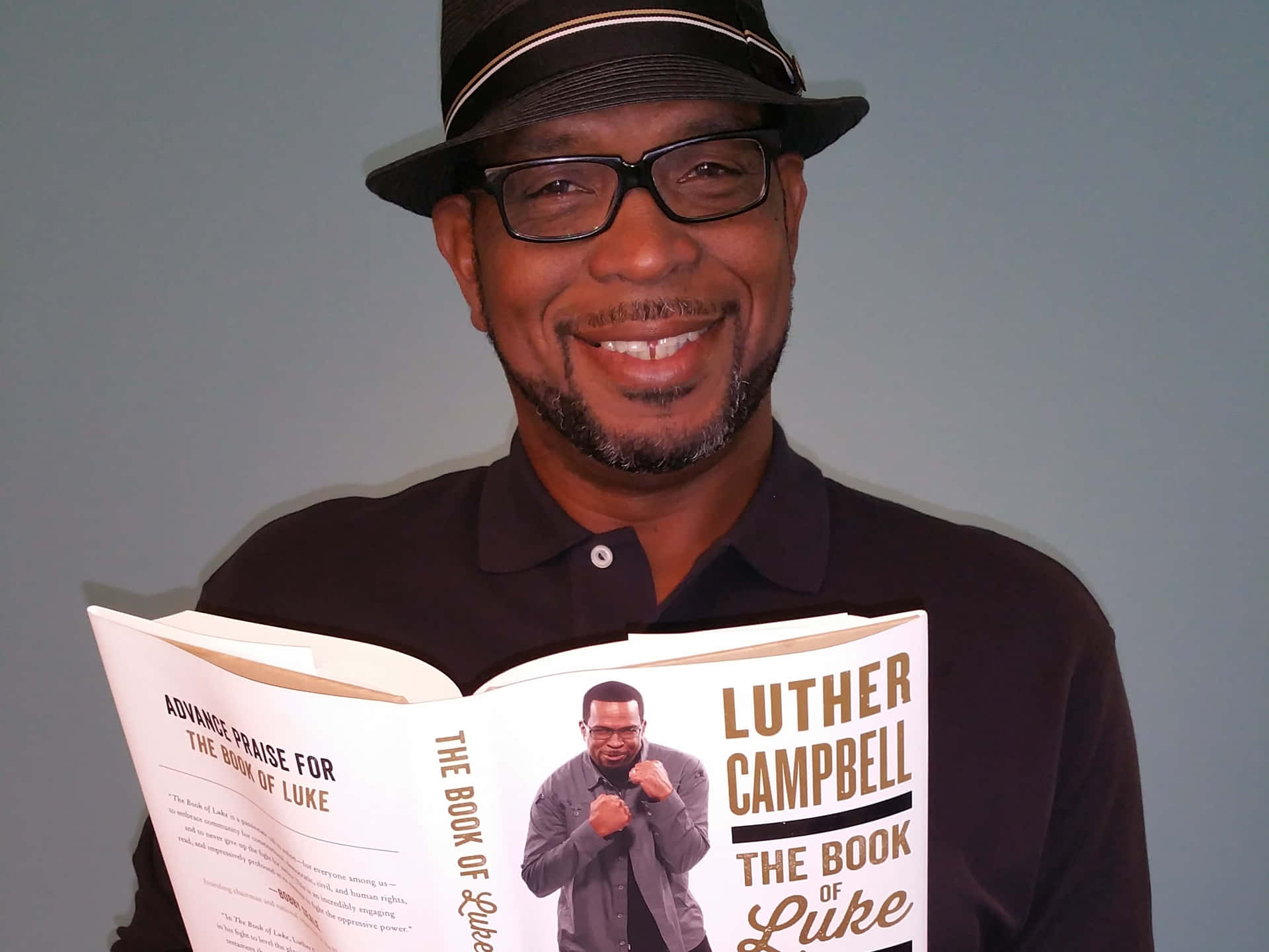 Luther Campbell Holding Book Wallpaper