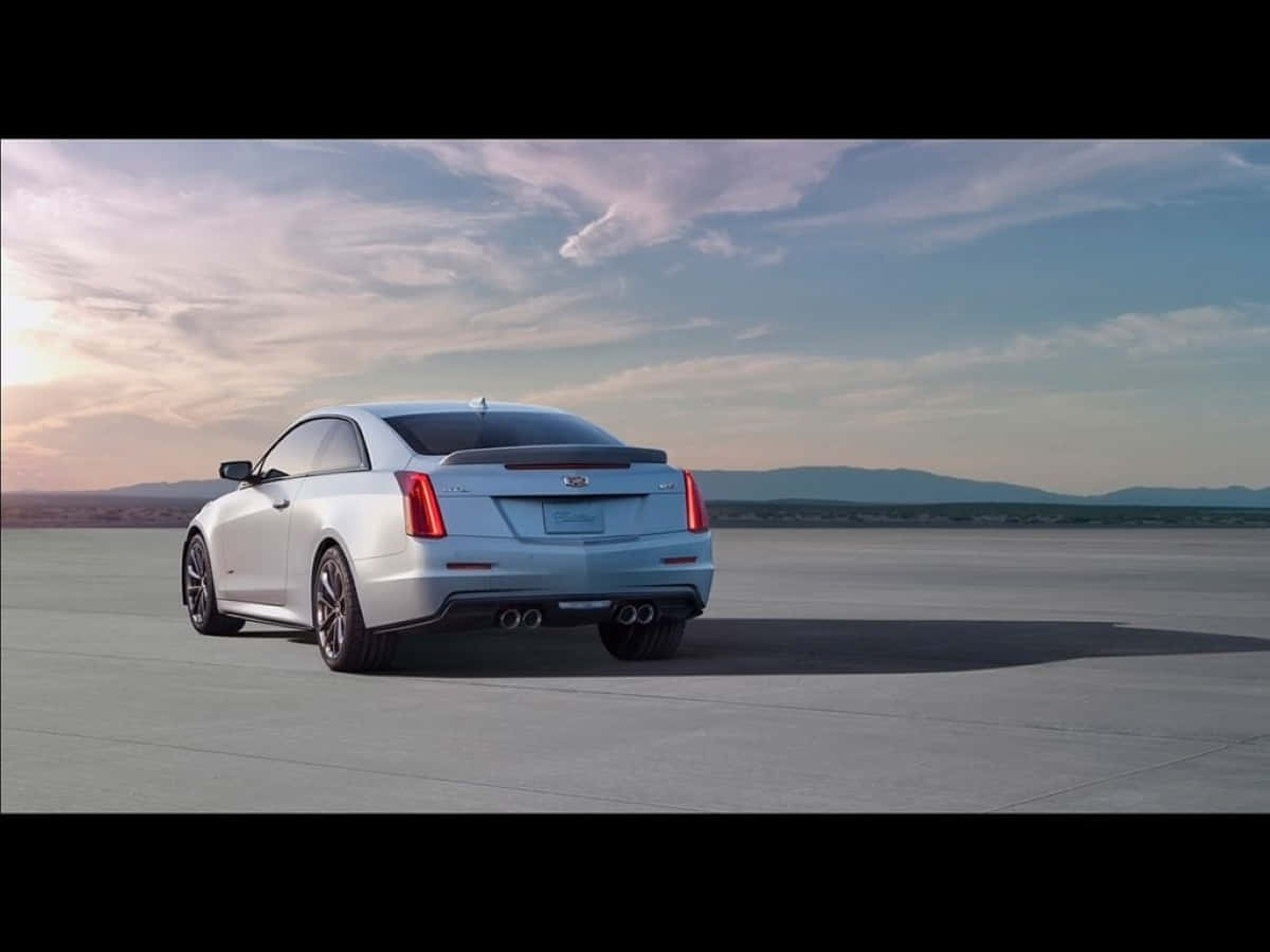 Luxurious Cadillac Ats Cruising On An Open Highway Wallpaper