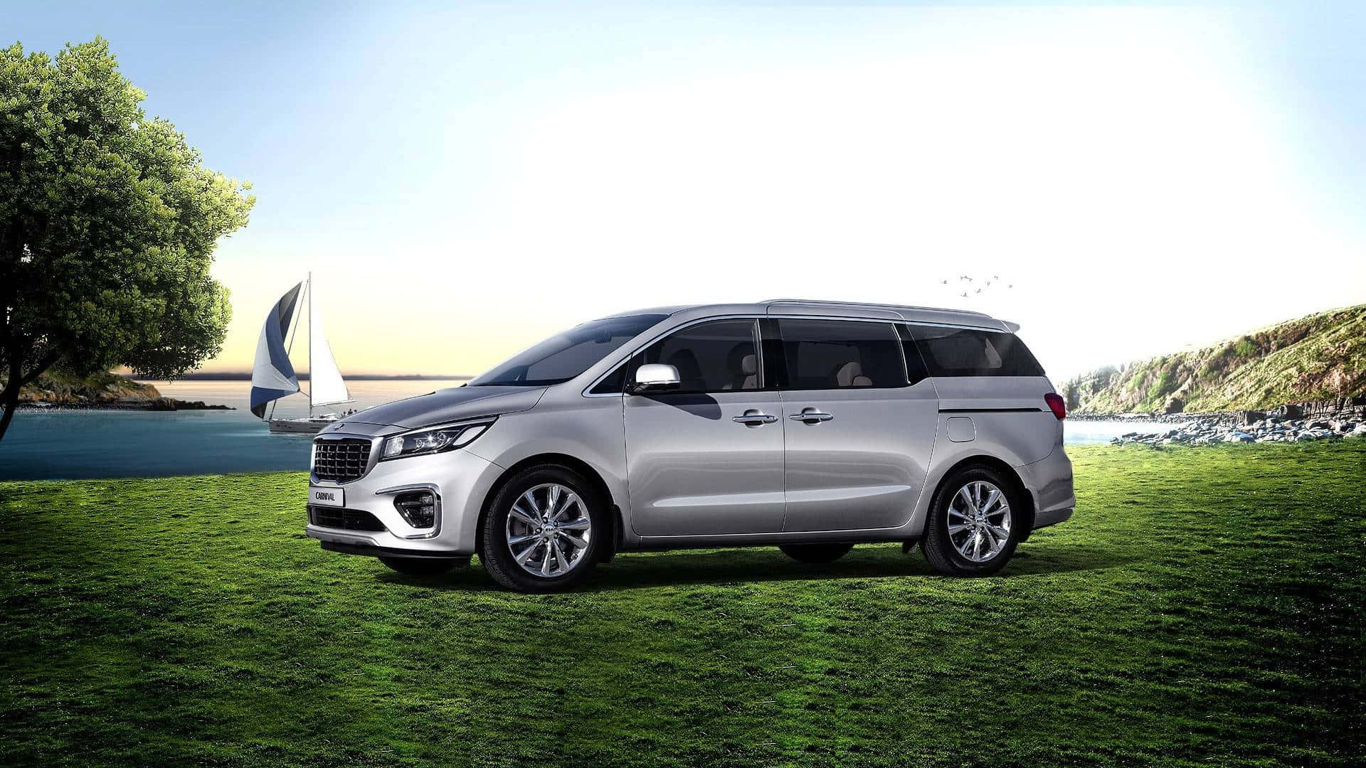 Luxurious Kia Carnival Cruising The City Streets Wallpaper